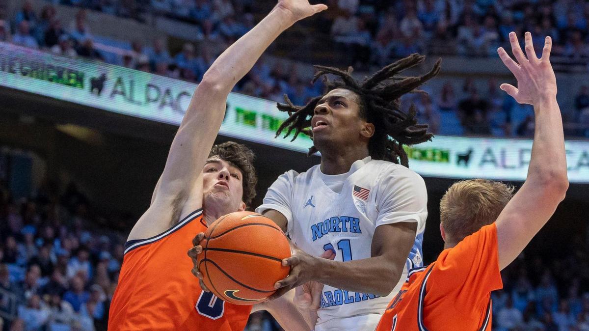 North Carolina guard Ian Jackson (11) drives to the basket against Virginia’s Blake Buchanan (0) and Andrew Rohde (4) in the first half on Saturday, February 22, 2025 at the Smith Center in Chapel Hill, N.C.