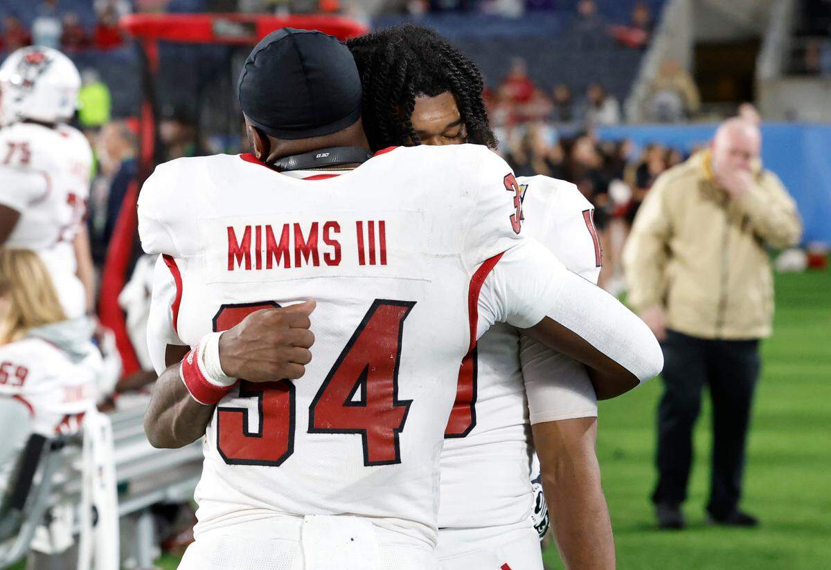 N.C. State’s KC Concepcion (10) and Delbert Mimms III (34) hug late in the fourth quarter during the second half of Kansas State’s 28-19 victory over N.C. State in the Pop-Tarts Bowl at Camping World Stadium in Orlando, Fla., Thursday, Dec. 28, 2023.