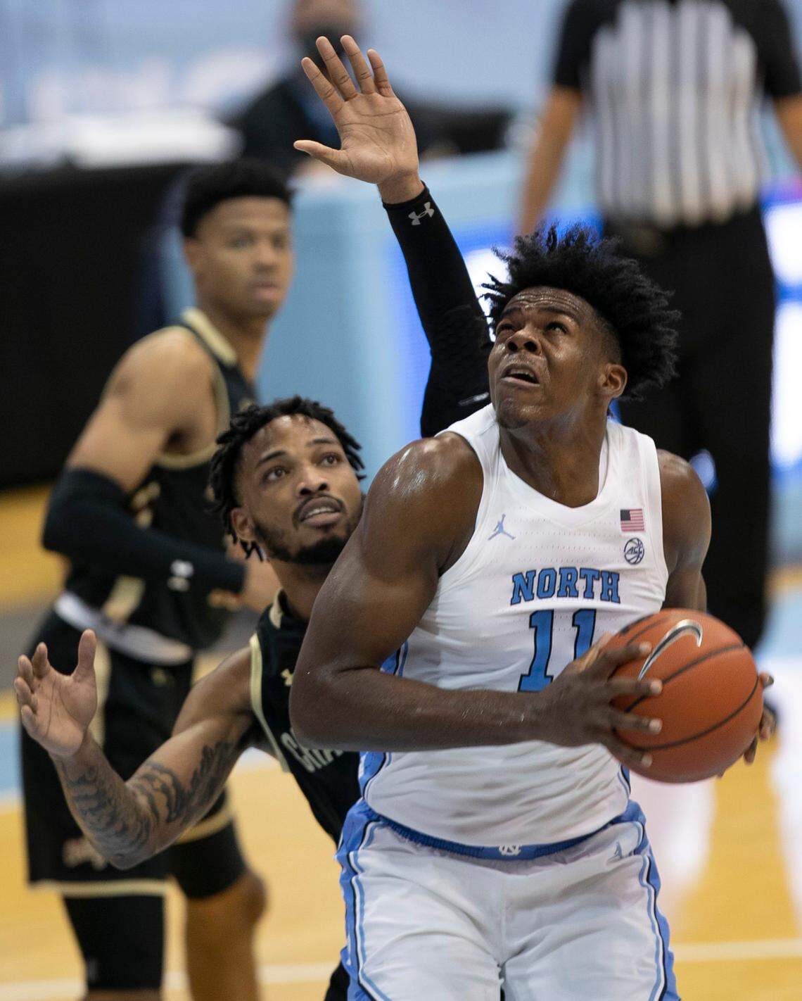North Carolina’s DayÕRon Sharpe (11) muscles his way to the basket against College of Charleston’s Dontavius King (4) during the second half on Wednesday, November 25, 2020 at the Smith Center in Chapel Hill, N.C. Sharpe scored 13 points in the Tar Heels’ 79-60 victory.
