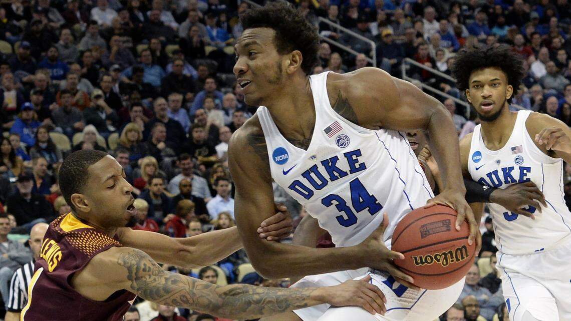 Iona's Zach Lewis (1) defends as Duke forward Wendell Carter Jr (34) in the NCAA tournament Round of 64 on Thursday.