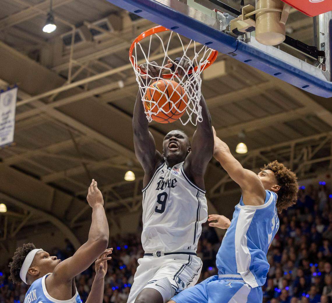 Duke center Khaman Maluach (9) dunks over North Carolina’s Ven-Allen Lubin (22) and Seth Trimble (7) in the first half on Saturday, February 1, 2025 at Cameron Indoor Stadium in Durham, N.C.