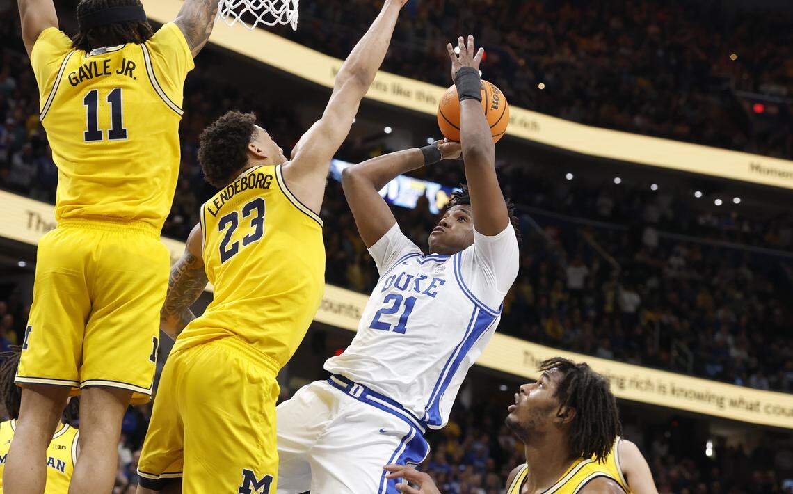 Duke’s Patrick Ngongba II (21) shoots in the final 24 seconds in the second half of Duke’s 68-63 victory over Michigan in the Capital Showcase at Capital One Arena in Washington, D.C., Saturday, Feb. 21, 2026. Ngongba II pulled in his own rebound and was fouled by Michigan's Elliot Cadeau.