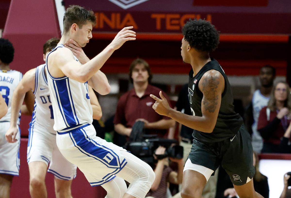 Duke’s Kyle Filipowski (30) reacts after being punched in the throat by Virginia Tech’s MJ Collins (2) late in the second half of Virginia Tech’s 78-75 victory over Duke at Cassell Coliseum in Blacksburg, VA., Monday, Jan. 23, 2023.