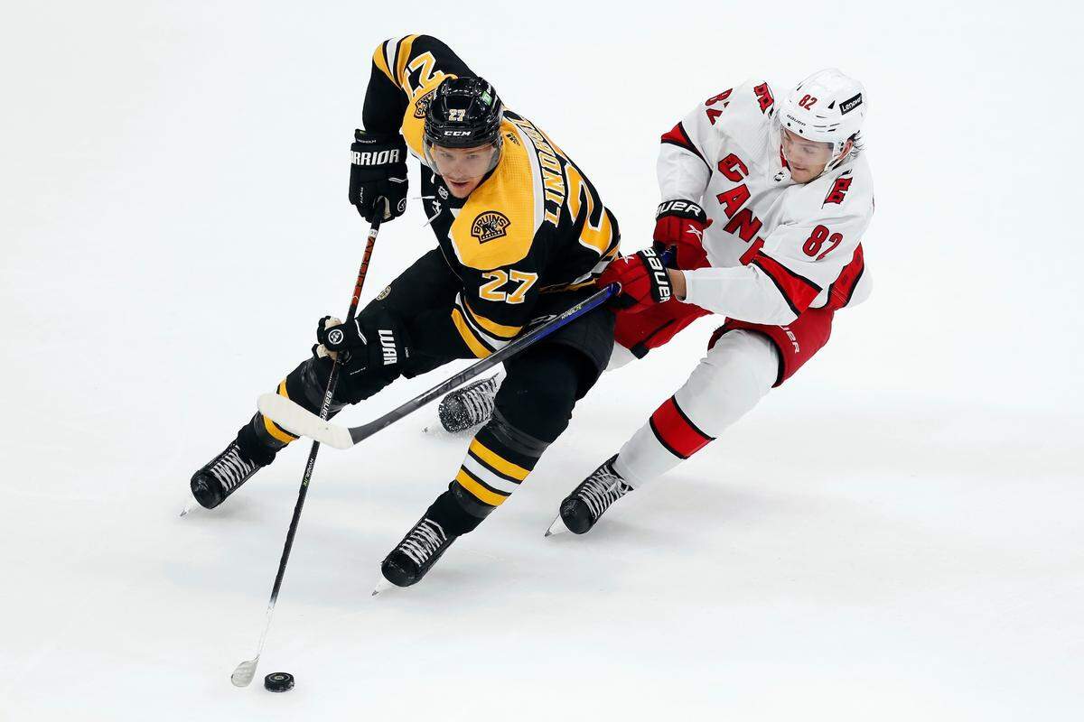 Carolina Hurricanes’ Jesperi Kotkaniemi (82) defends against Boston Bruins’ Hampus Lindholm (27) during the first period in Game 6 of an NHL hockey Stanley Cup first-round playoff series Thursday, May 12, 2022, in Boston.
