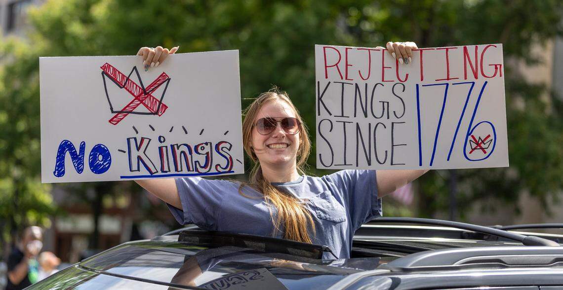 A demonstrator appears in sunroof of vehicle along Dawson Street at the North Carolina State Capitol during the ‘No Kings’ rally on Saturday, June 14, 2025 in Raleigh, N.C.