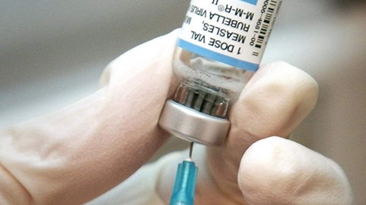 A nurse draws a dose of mumps-measles-rubella, or MMR, vaccine. 