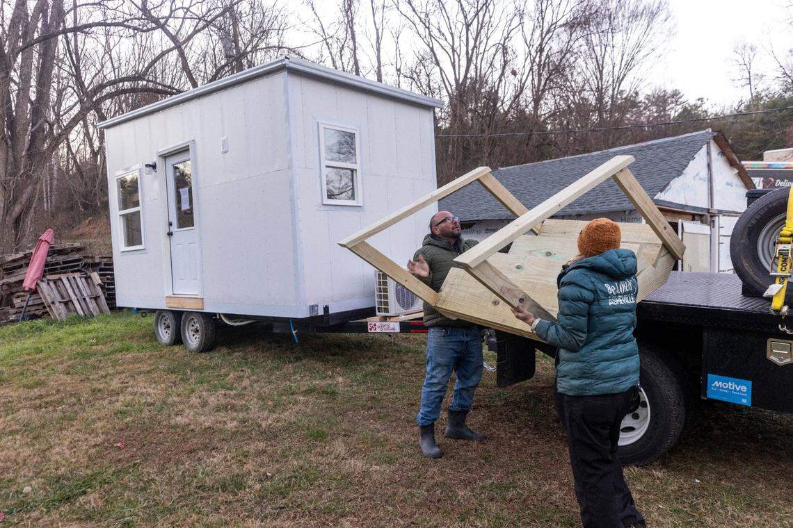 Co-directors of the nonprofit BeLoved Asheville, “Ponkho” Bermejo, left, and Amy Cantrell, help set up a tiny home for a resident in Leicester on Thursday, Dec. 5, 2024. From supplying meals to paying rent, Beloved Asheville has been helping to support Western North Carolina residents impacted by the remnants of Hurricane Helene.