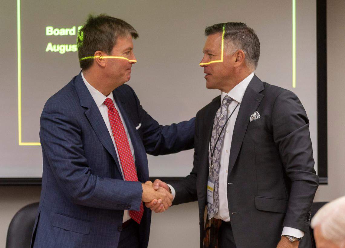 Centennial Authority Chairman Philip Isley shakes hands with Stacy Miller following their meeting on Tuesday, August 15, 2023 at PNC Arena in Raleigh, N.C.