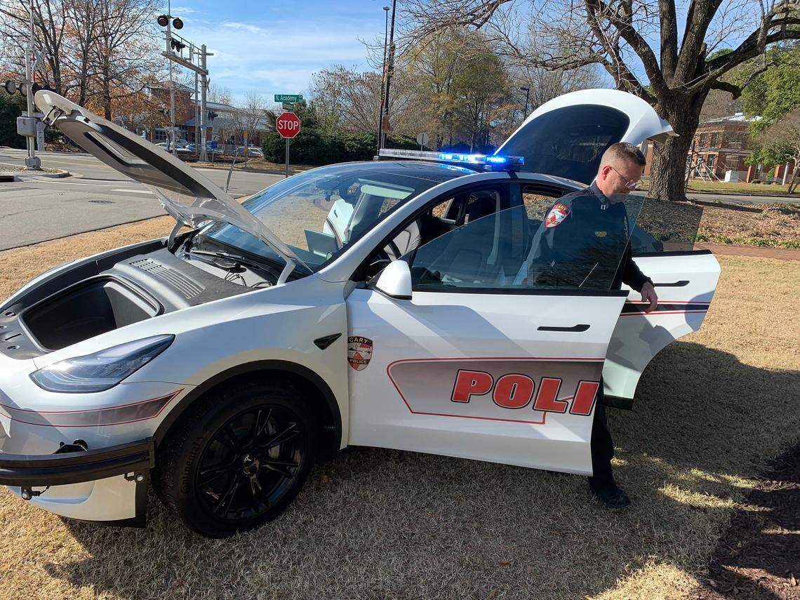 Capt. Brian Smith, who heads the Cary Police Department’s professional standards bureau, emerges from one of the department’s two new Tesla Model Y patrol cars on Dec. 16, 2021.