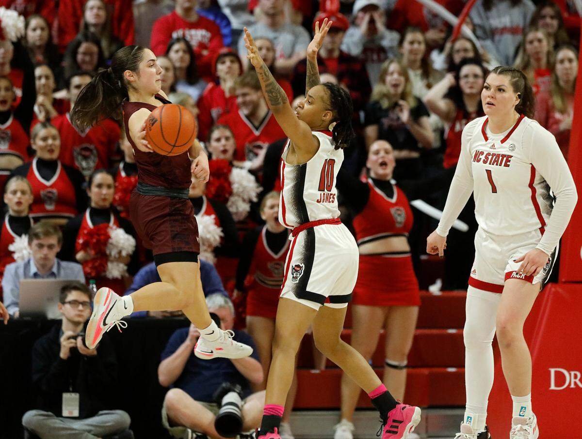 Virginia Tech’s Georgia Amoore looks to pass around N.C. State’s Aziaha James during the second half of the Wolfpack’s 72-61 loss on Thursday, Feb. 8, 2024, at Reynolds Coliseum in Raleigh, N.C.