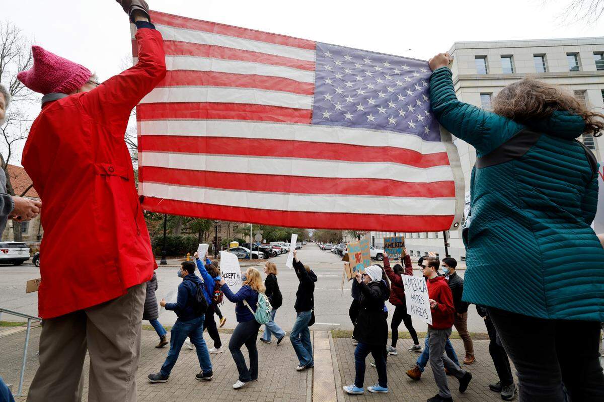 Protesters march around the North Carolina State Capitol building on Wednesday Feb. 5, 2025. The protest was part of a nationwide series of demonstrations in state capitals against the new administration of President Donald Trump.