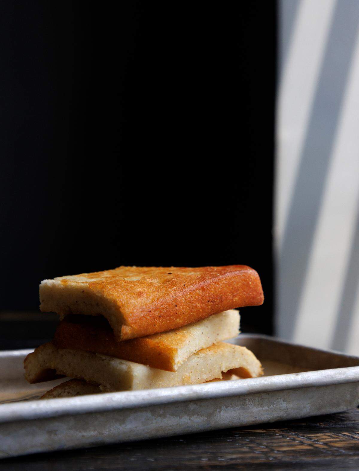 A stack of cornbread is photographed at Sam Jones BBQ in Raleigh, N.C. Triangle customers can order Sam Jones BBQ for delivery through third-party platforms such as Uber Eats and Grubhub.
