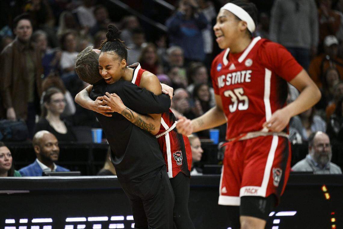 Mar 31, 2024; Portland, OR, USA; NC State Wolfpack guard Aziaha James (10) celebrates with head coach Wes Moore, along with guard Zoe Brooks (35) after defeating theTexas Longhorns in the finals of the Portland Regional of the NCAA Tournament at the Moda Center center. Mandatory Credit: Troy Wayrynen-USA TODAY Sports