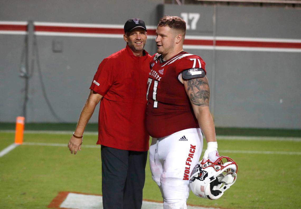N.C. State head coach Dave Doeren congratulates guard Joe Sculthorpe (71) after N.C. State’s 45-42 victory over Wake Forest at Carter-Finley Stadium in Raleigh, N.C, Saturday, Sept. 19, 2020.