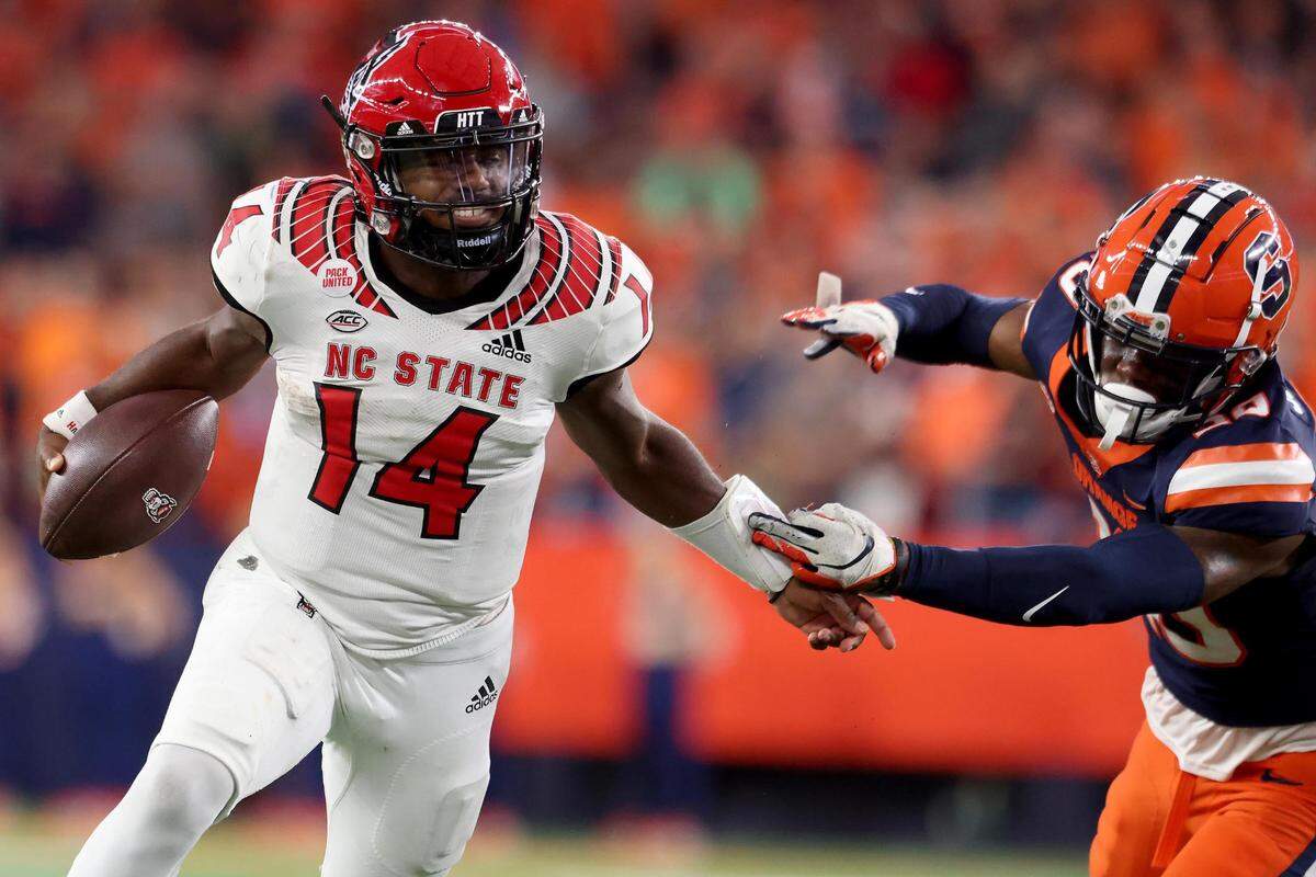 North Carolina State’s Jack Chambers (14) battles for yardage against Syracuse’s Isaiah Johnson (20) during the fourth quarter at JMA Wireless Dome on Saturday, Oct. 15, 2022, in Syracuse, New York.