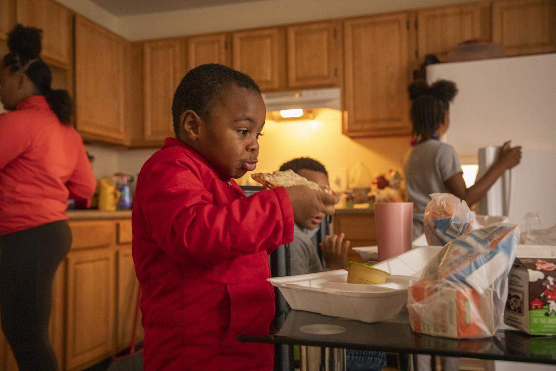 J-Sheer Williams, 3, eats a lunch of pizza, butternut squash and apple sauce at home with his siblings, provided at one of about 67 meal distribution sites for Durham Public Schools students as all North Carolina public schools remain closed until May 15, 2020, in an effort to slow the spread of the coronavirus, on Thursday, Mar. 26, 2020, in Durham, N.C.