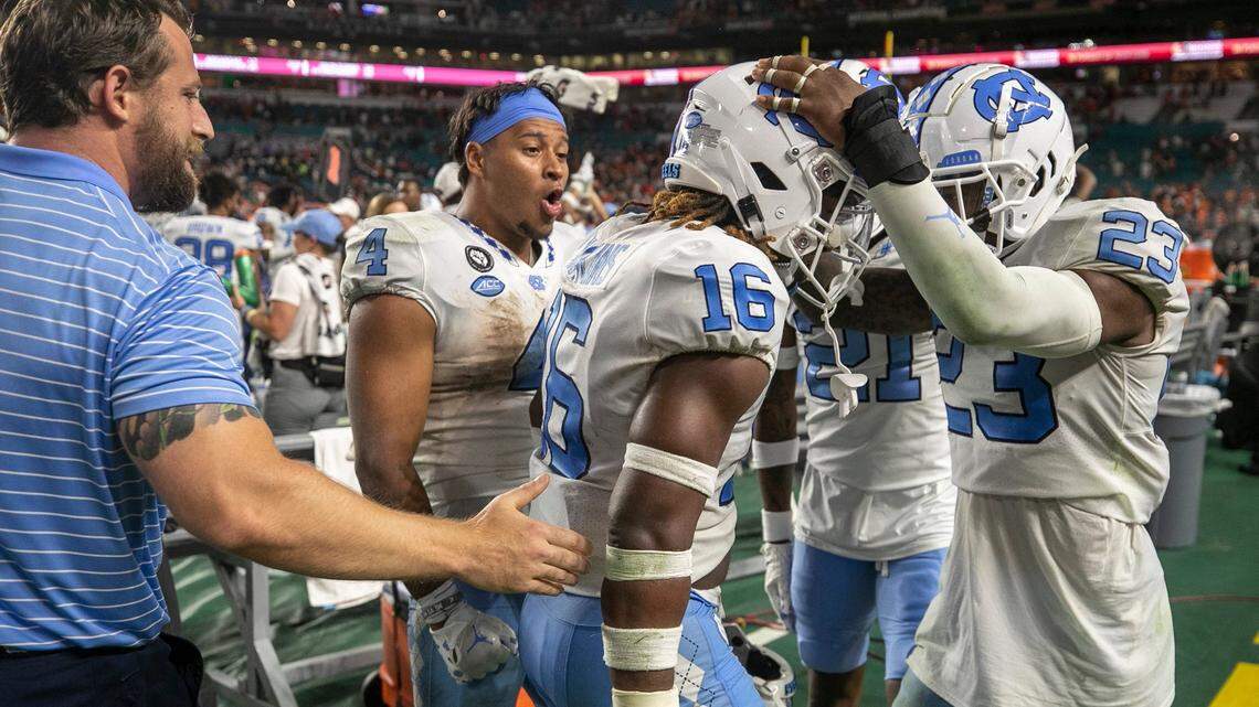 North Carolina defensive back DeAndre Boykins (16) celebrates with teammate Power Echols (23) after Boykins’ interception of Miami quarterback Tyler Van Dyke with eight seconds to play to secure the Tar Heels’ 27-24 victory on Saturday, October 8, 2022 at Hard Rock Stadium in Miami Gardens, Florida.