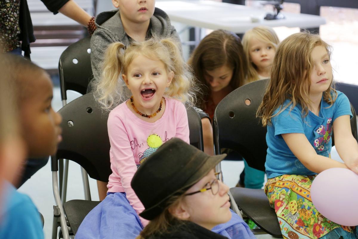 Five-year-old Cora May Baird, center, laughs out loud as the students look at a picture book during the weekly Homeschool Explorers meeting for students and parents at Method Community Center in Raleigh on Tuesday, Nov. 27, 2018.