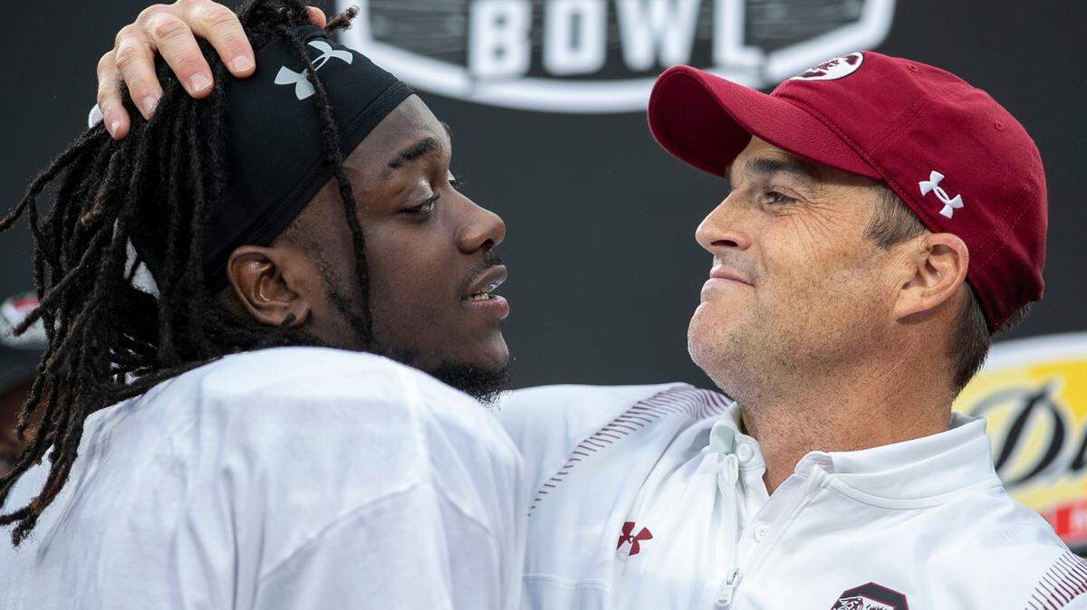 South Carolina coach Shane Beamer embraces wide receiver Dakereon Joyner (5) during the trophy presentation following the Gamecocks’ victory over North Carolina in the Duke’s Mayo Bowl on Thursday, December 30, 2021 at Bank of America Stadium in Charlotte, N.C.