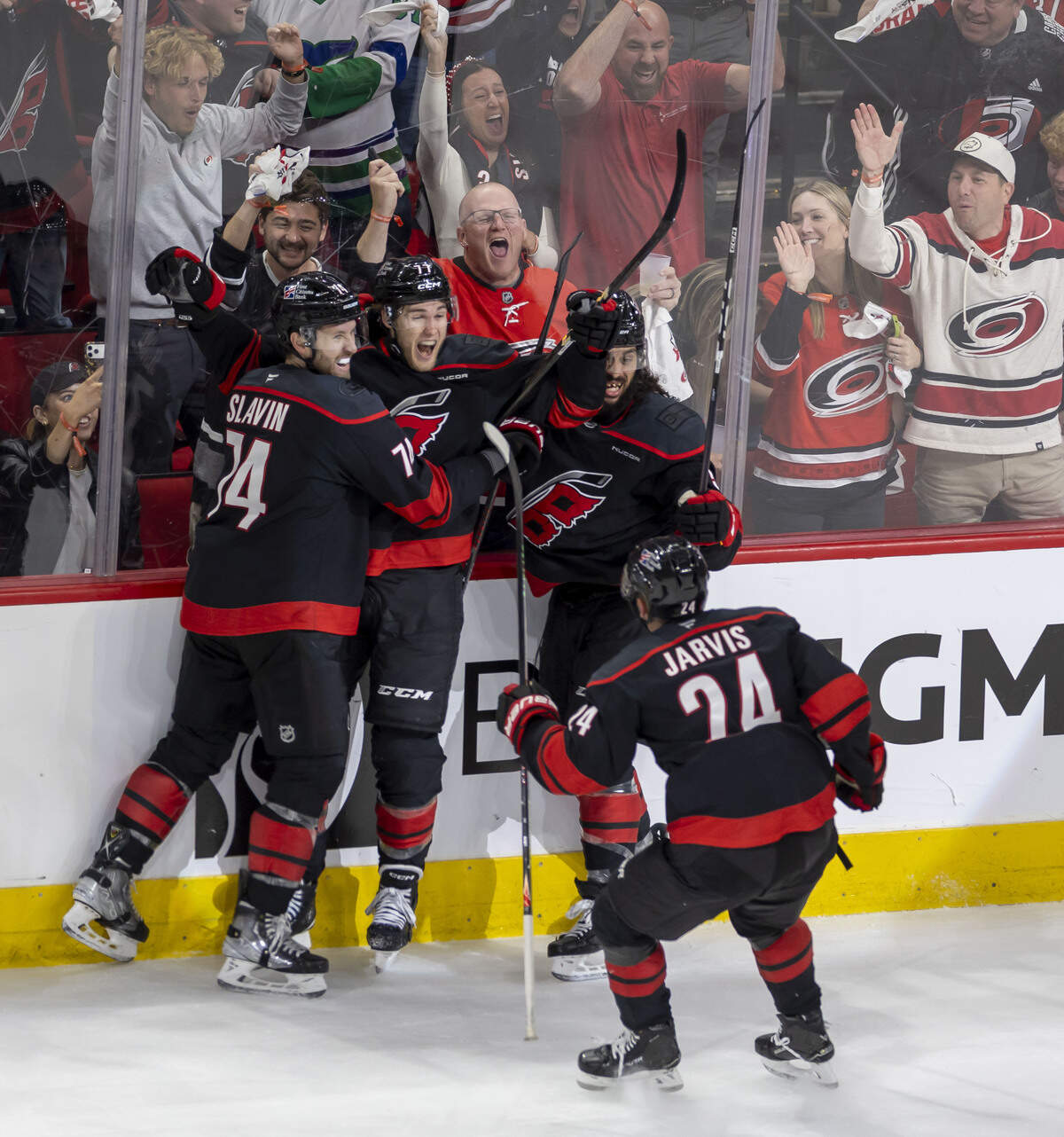 Carolina Hurricanes left wing Mark Jankowski (77) celebrates with teammates Jacoob Slavin (74) Jalen Chatfield (5) and Seth Jarvis (24) after scoring a goal in the first overtime period of Game 2 against Ottawa on Monday, April 20, 2026 during the first round of the Stanley Cup Playoffs at Lenovo Center in Raleigh, N.C.