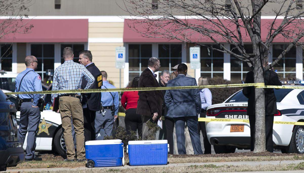 Raleigh Police, the Wake County Sheriff’s department and CCBI investigate outside the Golden Corral on US 401 south of downtown Raleigh, Thursday, February 14, 2019 after a suspect in a shooting at a Walgreens in Garner was apprehended here. The suspect allegedly injured two employees at the Walgreens.