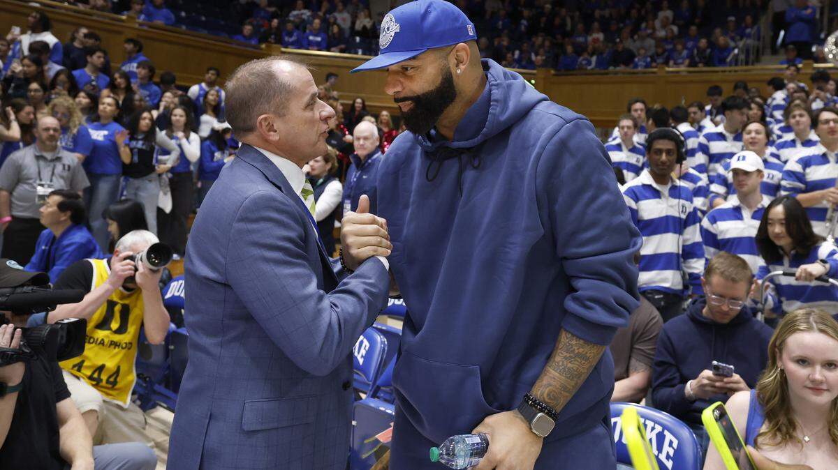 ACC Commissioner Jim Phillips talks with Carlos Boozer before Duke’s game against Clemson at Cameron Indoor Stadium in Durham, N.C., Sat., Feb. 14, 2026.