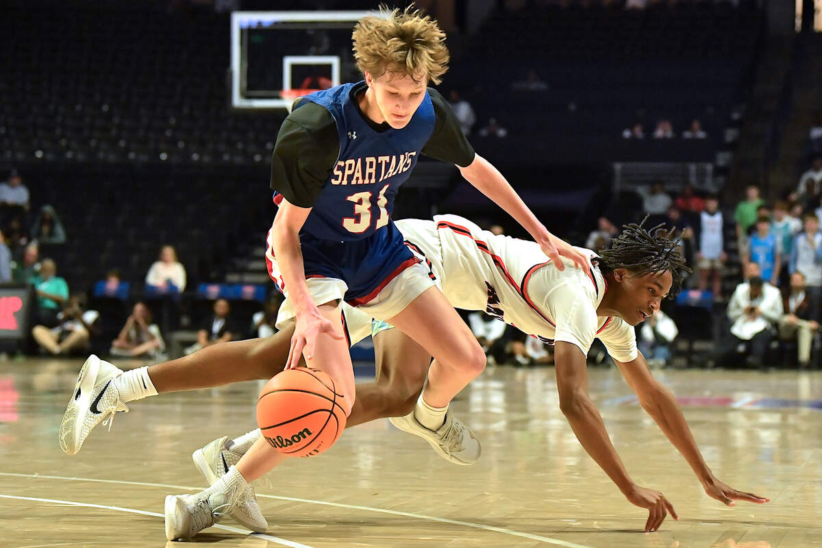 Sanderson’s Mack Snavely (31) controls the ball against New Hanover’s Kellum Brown (0) during the second half. The Sanderson Spartans and the New Hanover Wildcats met in the NCHSAA 4A East Regional Final in Winston-Salem, N.C. on March 12, 2025.