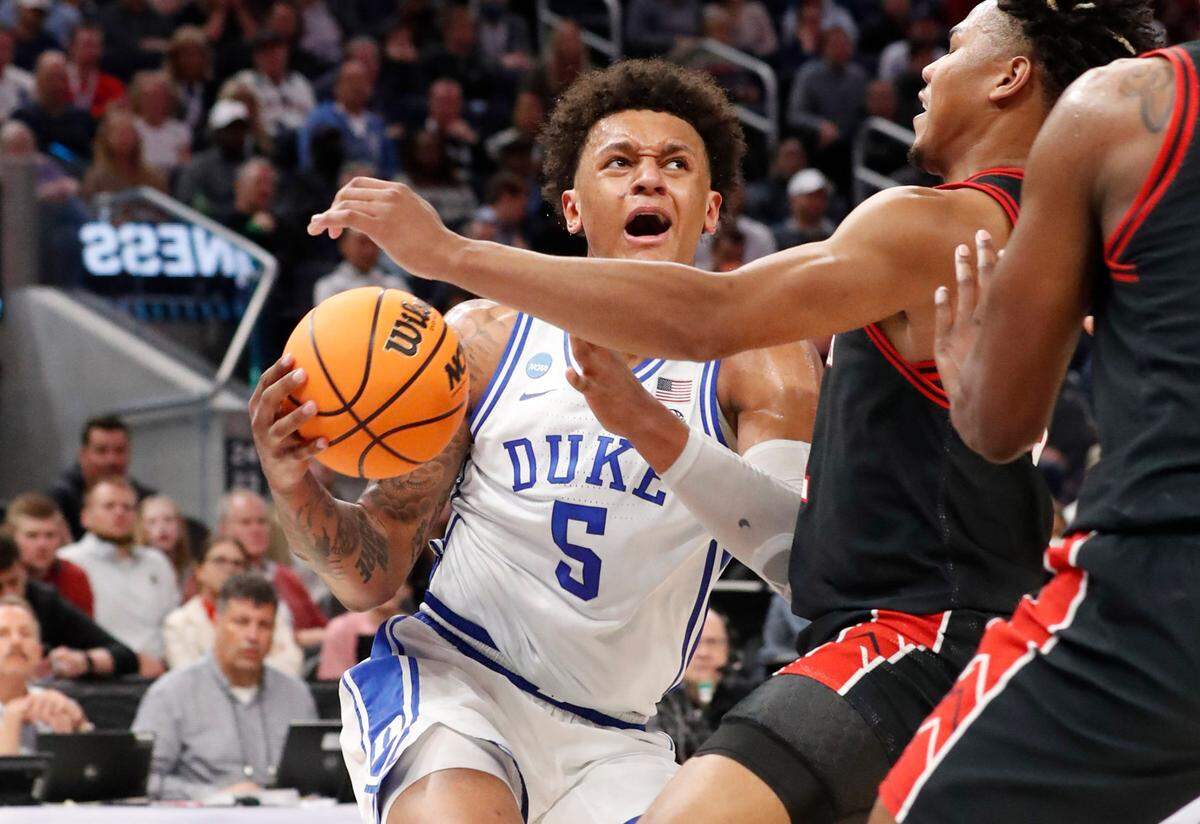 Duke’s Paolo Banchero (5) drives as Texas Tech’s Terrence Shannon Jr. (1) defends during the second half of Duke’s 78-73 victory over Texas Tech in the Sweet 16 round of the NCAA Tournament at the Chase Center in San Francisco, Calif., Thursday, March 24, 2022.