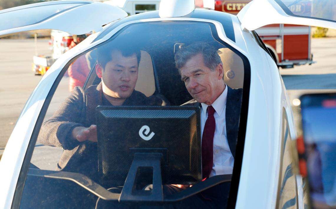 Derrick Xiong, Ehang’s cofounder, talks with Gov. Roy Cooper in the EH 216, a two-seat drone, after it flew during what was billed as North America’s first public demonstration flight of a pilot-less air taxi. The drone was demonstrated at State Highway Patrol’s test track in Raleigh, N.C., Tuesday, Jan. 7, 2020.