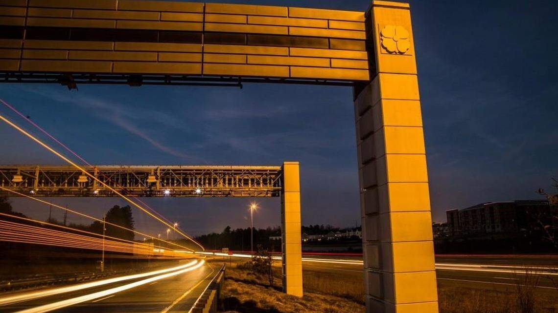 Traffic flows under automatic toll readers on the Triangle Expressway near Hopson Road in Morrisville.