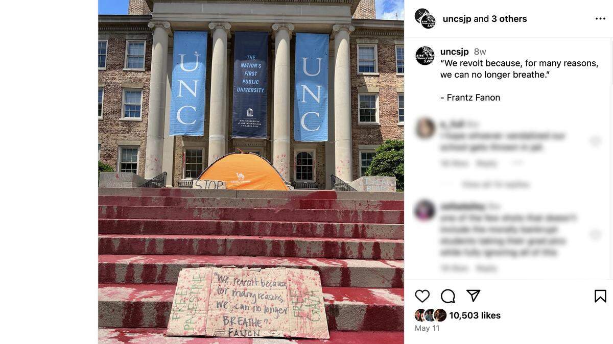 A post from the Instagram page of UNCSJP shows red paint on the steps of South Building on the UNC campus.