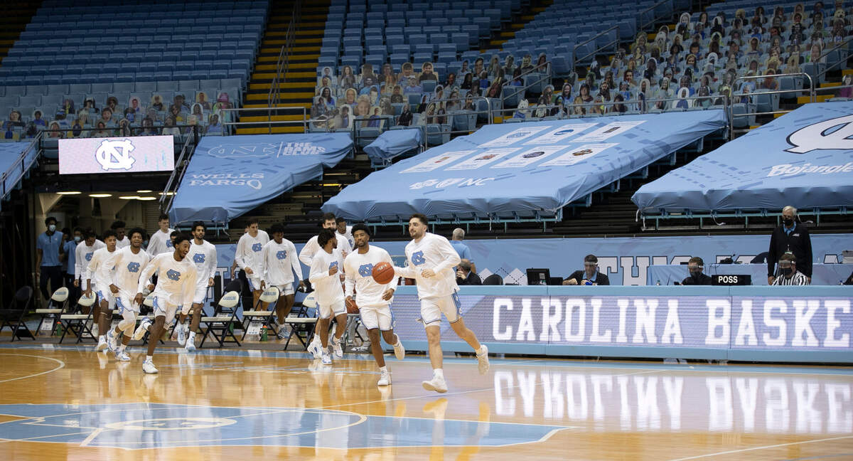 North Carolina senior Andrew Platek (3) leads the Tar Heels into a nearly empty Smith Center for the Tar Heels’ game against College of Charleston on Wednesday, November 25, 2020 in Chapel Hill, N.C.