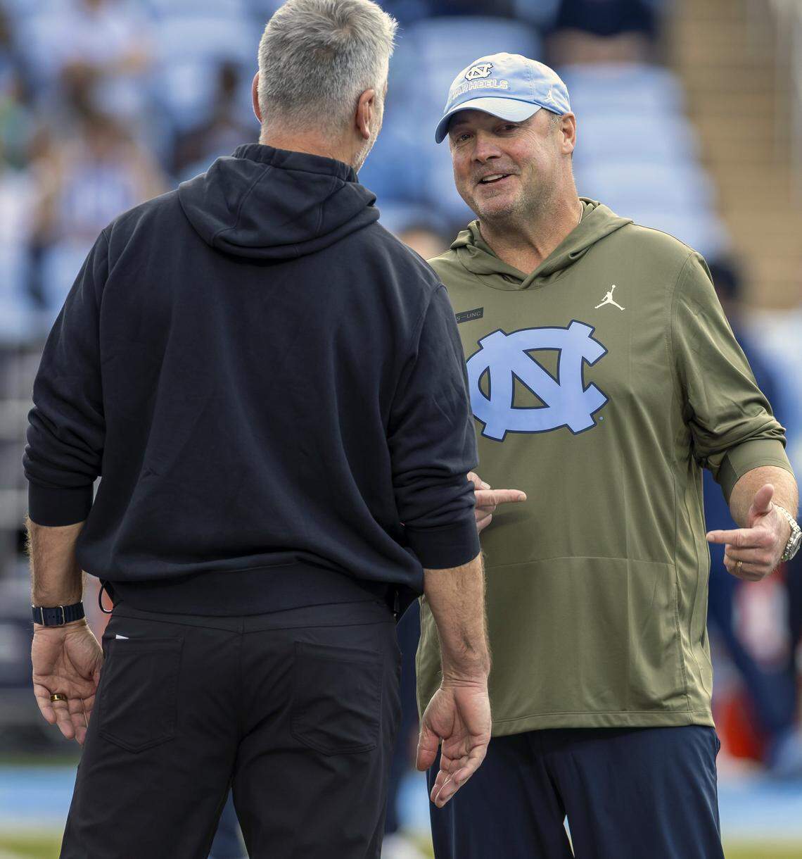 North Carolina offensive coordinator Freddie Kitchens talks with Stanford head coach Frank Reich prior to their game on Saturday, November 8, 2025 at Kenan Stadium in Chapel Hill, N.C.
