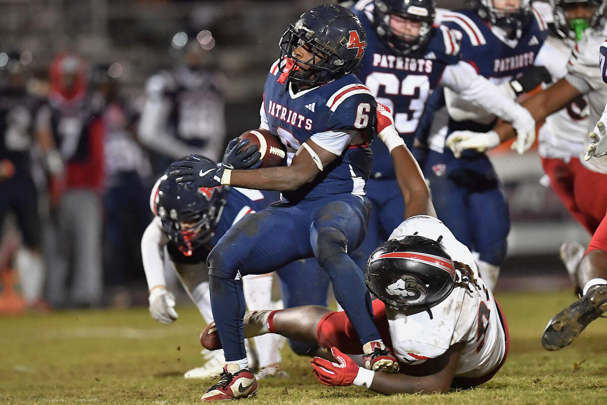 Rolesville defensive lineman Genesis Allen (90) grapples Apex Friendship running back Michael Mallard (6) during the second half. The Apex Friendship Patriots and the Rolesville Rams met in  the second round of the  NCHSAA 8A Playoff game in Apex, N.C. on November 14, 2025. Rolesville wins 14-7 in overtime.