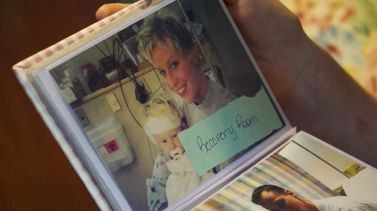 Alexis Nye shows a photo of her and her mother Jodi Nye after a cochlear implant surgery when she was a child. The small electronic device is surgically placed near the ear to partially allow hearing. At age 16, she got a second cochlear implant surgery for her other ear.