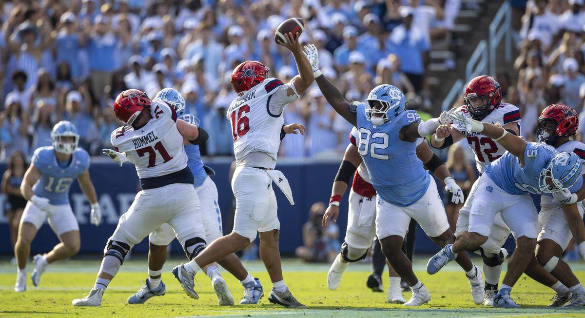 Richmond quarterback Kyle Wickersham (16) is pressured by North Carolina defensive lineman C.J. Mims (92) in the third quarter on Saturday, September 13, 2025 at Kenan Stadium in Chapel Hill, N.C.