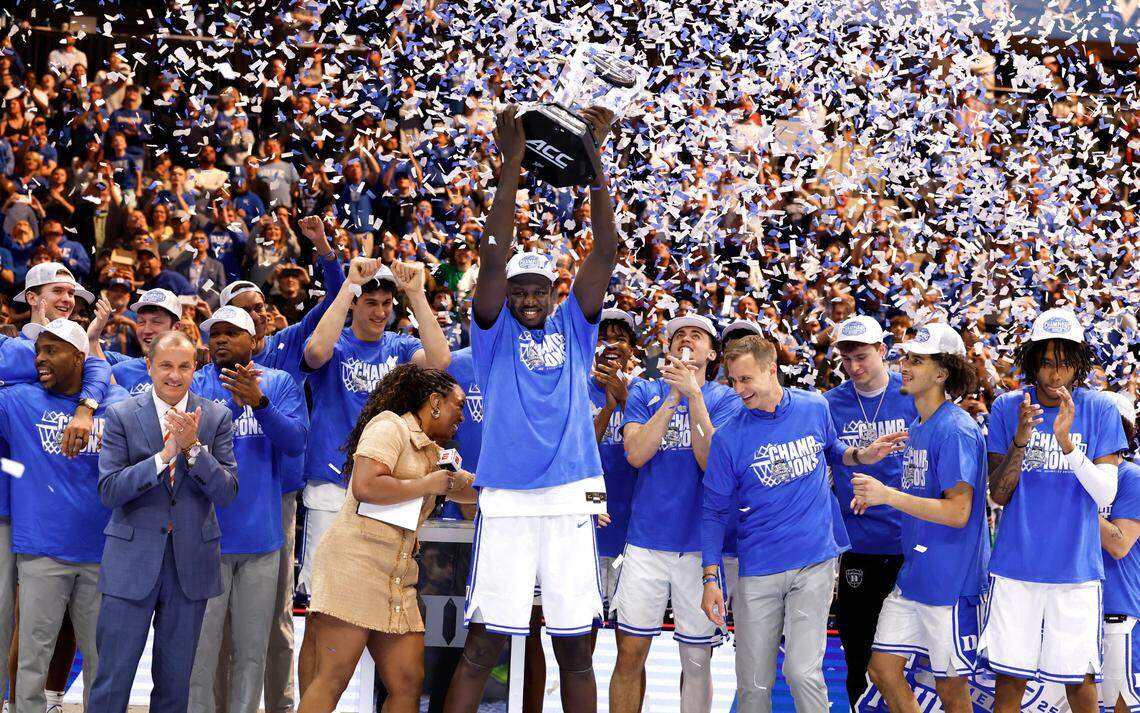 Duke’s Khaman Maluach (9) holds up the championship trophy after Duke’s 73-62 victory over Louisville in the finals of the 2025 ACC Men’s Basketball Tournament at the Spectrum Center in Charlotte, N.C., Saturday, March 15, 2025.