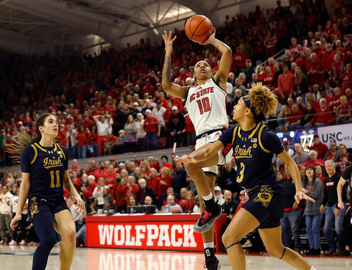 N.C. State’s Aziaha James drives past Notre Dame’s Sonia Citron and Hannah Hidalgo during the second half of the Wolfpack’s 104-95 double overtime win on Sunday, Feb. 23, 2025, at Reynolds Coliseum in Raleigh, N.C.