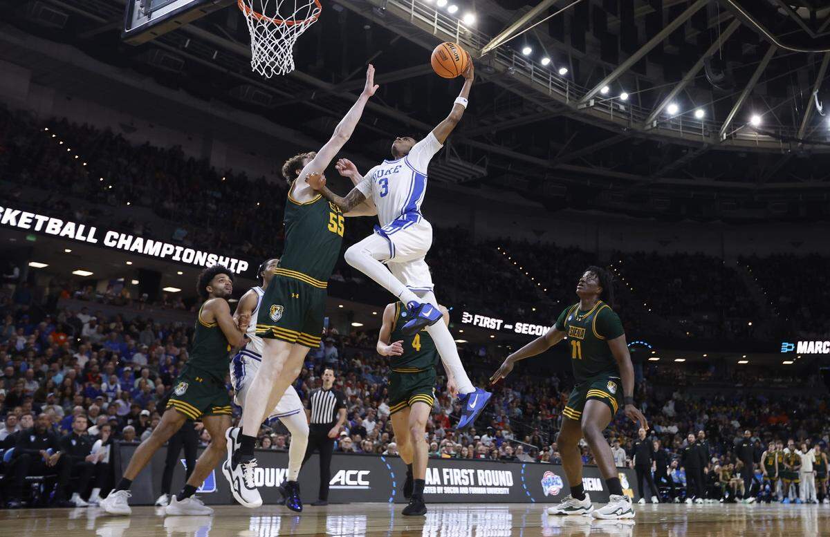 Duke’s Isaiah Evans (3) goes up to slam in two during Duke’s 71-65 victory over Siena in the first round of the NCAA Men’s Basketball Tournament at  Bon Secours Wellness Arena in Greenville, S.C., Thursday, March 19, 2026.