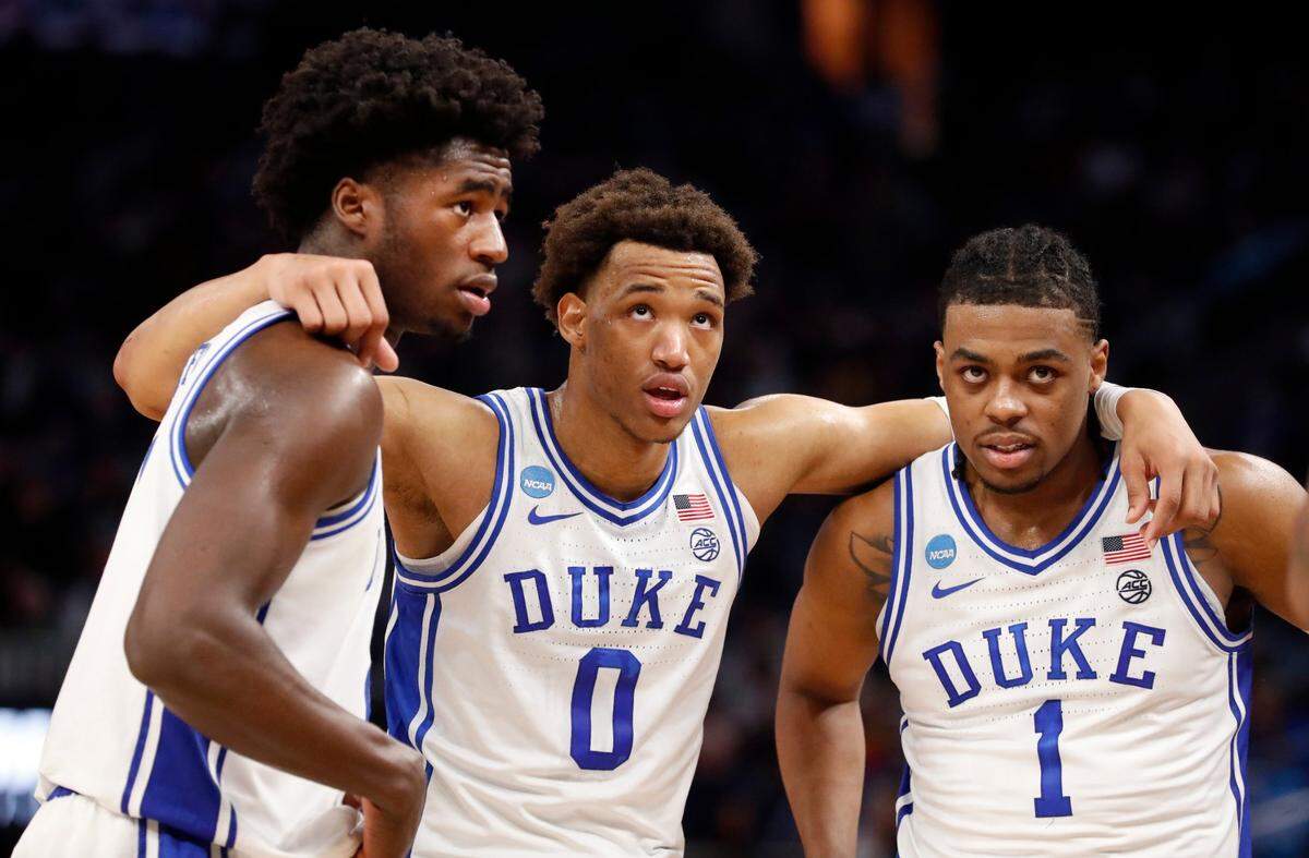 Dukes AJ Griffin (21), Wendell Moore Jr. (0) and Trevor Keels (1) huddle after a timeout during the second half of Dukes 78-69 victory over Arkansas in the NCAA Tournament West Regional finals at the Chase Center in San Francisco, Calif., Saturday, March 26, 2022.
