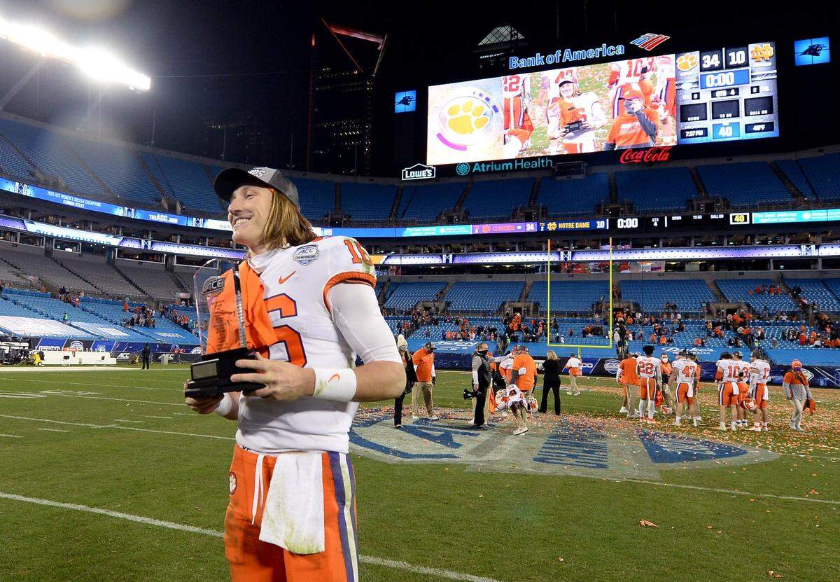 Clemson Tigers quarterback Trevor Lawrence smiles as he hold the MVP trophy following the teamÕs victory in the ACC Championship game. Clemson defeated Notre Dame 34-10 to win the championship at Bank of America Stadium in Charlotte, NC on Saturday, December 19, 2020.