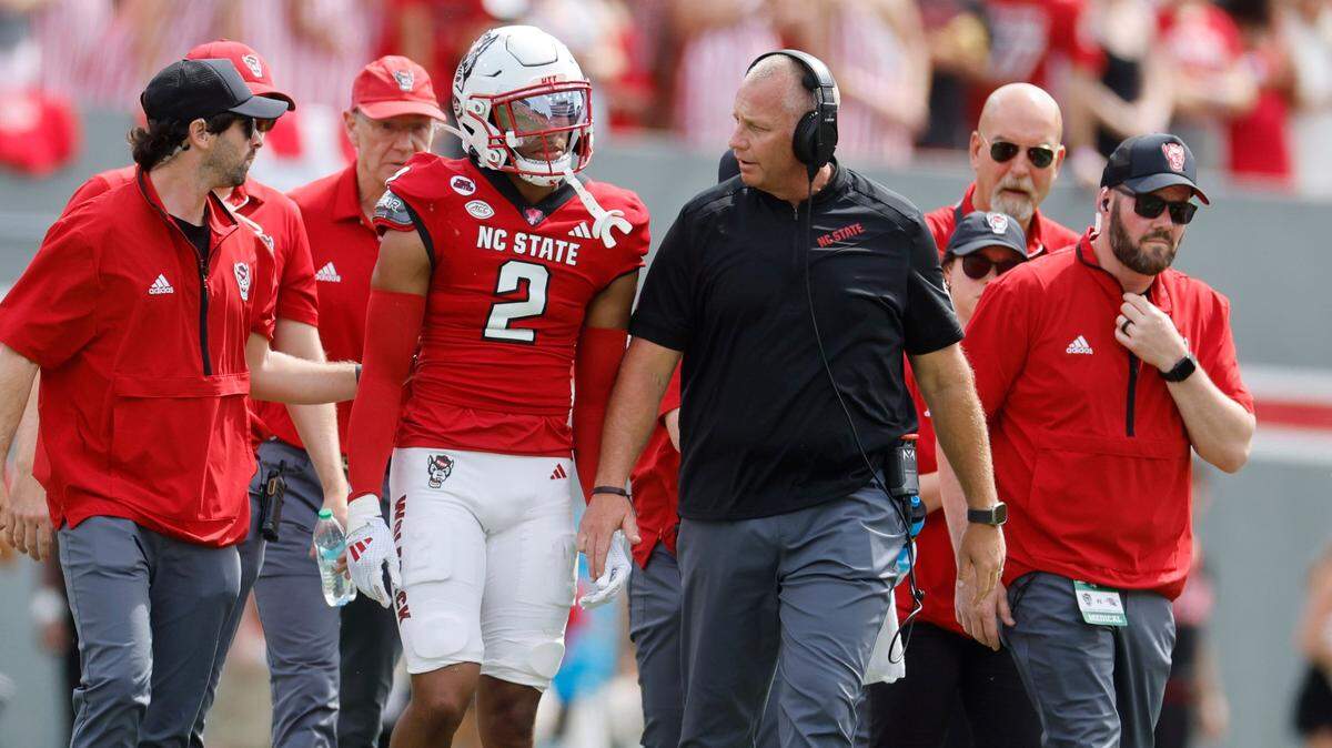 N.C. State head coach Dave Doeren talks with cornerback Brandon Cisse (2) after he was injured during the first half of N.C. State’s game against LA Tech at Carter-Finley Stadium in Raleigh, N.C., Saturday, Sept. 14, 2024.