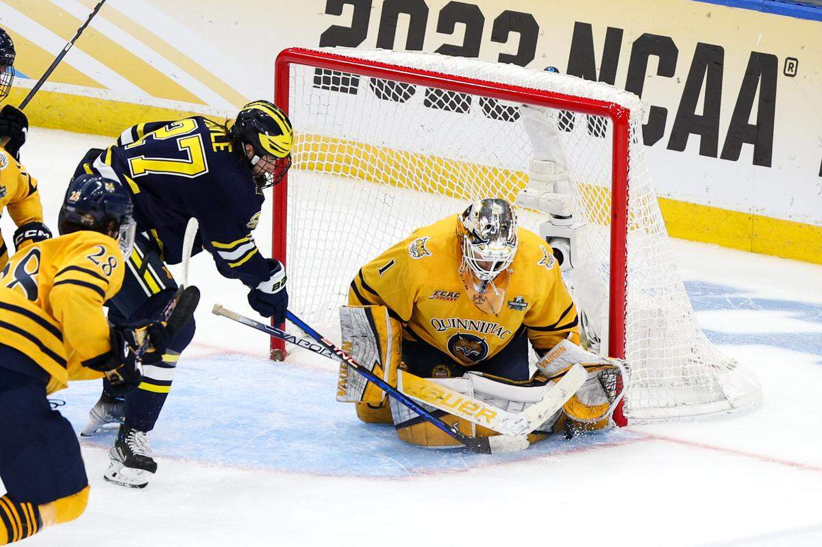 Quinnipiac goaltender Yaniv Perets (1) saves a shot from Michigan forward Nolan Moyle (27) during the second period in the semifinals of the 2023 Frozen Four college ice hockey tournament at Amalie Arena.