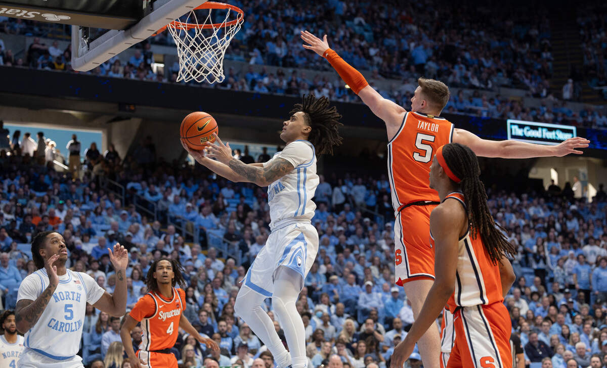 North Carolina’s Elliot Cadeau (2) drives to the basket against Syracuse’s Justin Taylor (5) in the second half on Saturday, January 13, 204 at the Smith Center in Chapel Hill, N.C.