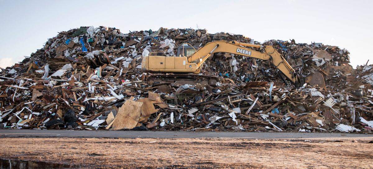 Debris from hundreds of homes and businesses is piled high in a beach access parking lot, pictured here on Sunday, Nov. 24, 2019, almost three months after Hurricane Dorian caused a historic flood on Ocracoke, N.C.
