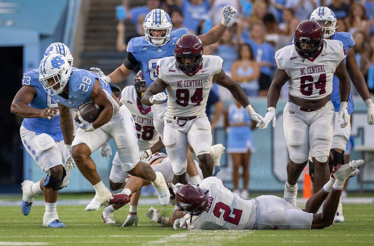 North Carolina running back Omarion Hampton (28) breaks away from N.C. Central defensive back Malcolm Reed for a 53-yard gain in the second quarter on Saturday, September 14, 2024 at Kenan Stadium in Chapel Hill, N.C