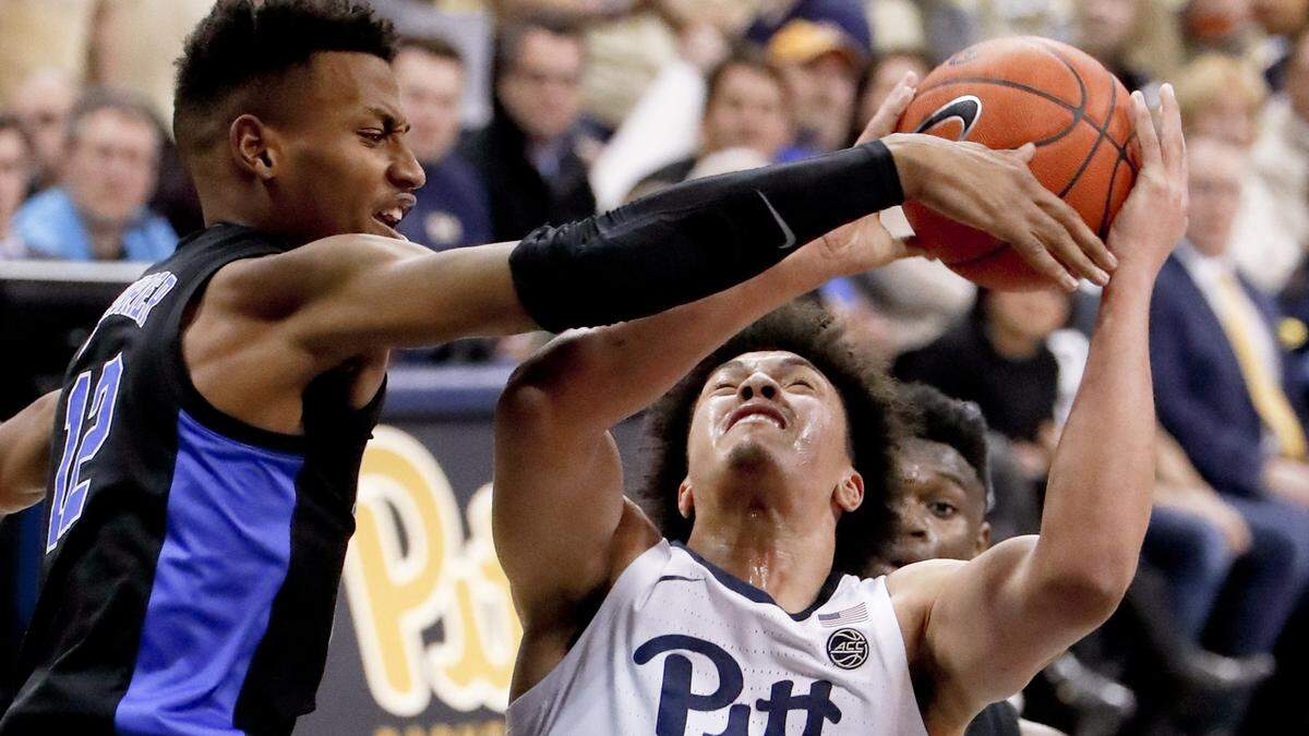 Pittsburgh’s Kene Chukwuka (15) tries to shoot as Duke’s Javin DeLaurier (12) defends during the first half of an NCAA college basketball game, Tuesday, Jan. 22, 2019, in Pittsburgh.