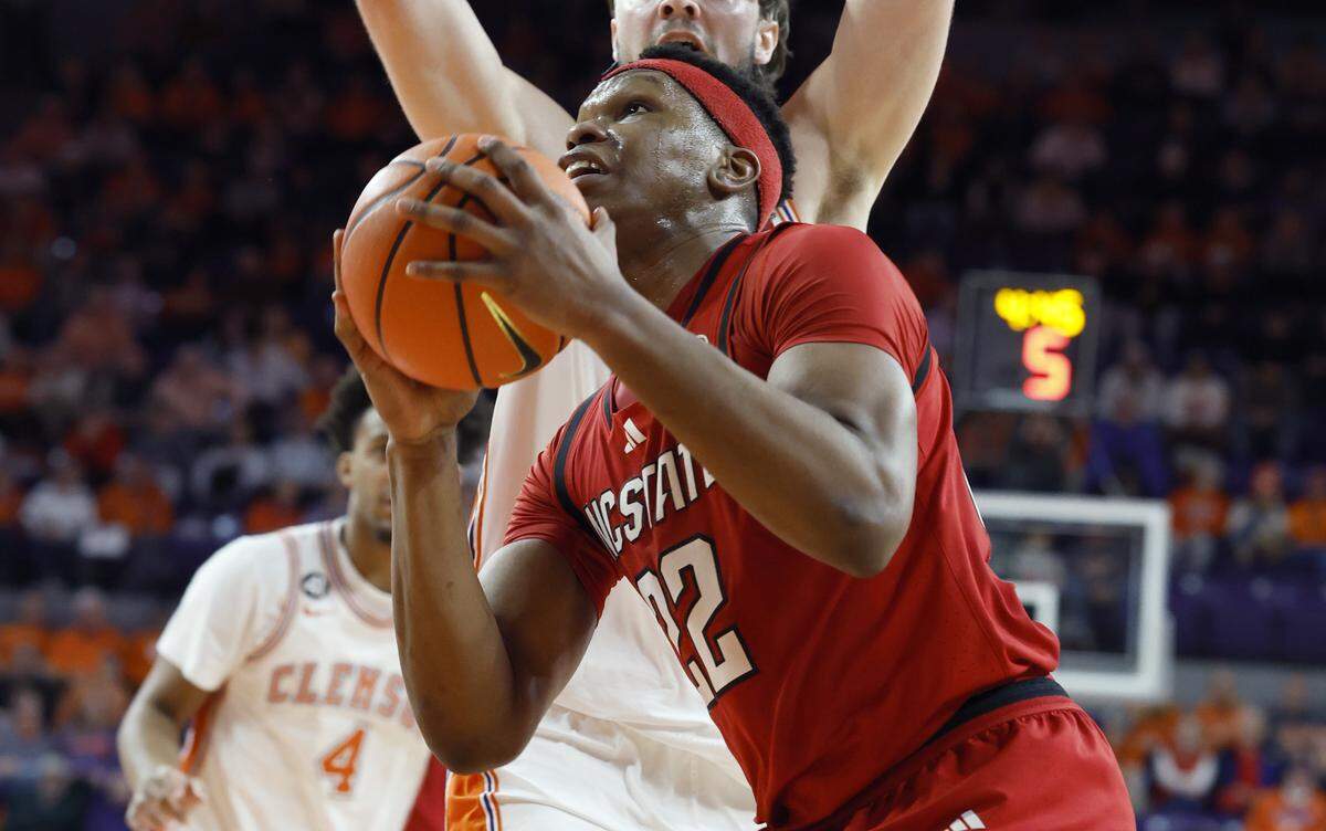N.C. State's Ven-Allen Lubin (22) drives to the basket past Clemson's Carter Welling (22) during the second half of N.C. State’s 80-76 overtime victory over Clemson at Littlejohn Coliseum in Clemson, S.C., Tuesday, Jan. 20, 2026.