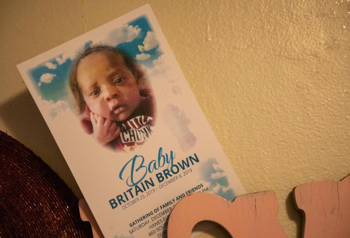 The funeral announcement for Brittany Brown’s infant son Britain who she believes died, on Dec. 8, 2019, from carbon monoxide poisoning, decorates the in their apartment at McDougald Terrace, on Friday, Jan. 3, 2020, in Durham, N.C.