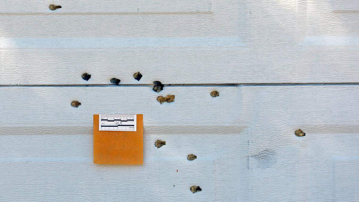 Shotgun pellet holes in the garage door of the home of Tracey Howard and his late wife, Nicole Connors, photographed Wednesday, Oct. 19, 2022. Connors was killed in a mass shooting in the Hedingham neighborhood on Thursday, Oct. 13.